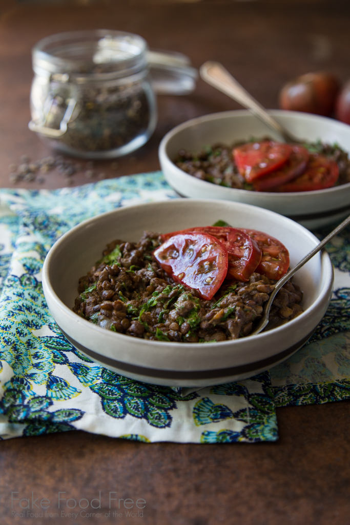 Lentils cooked in coconut milk and garam masala with mustard greens and heirloom tomatoes | Recipe at FakeFoodFree.com