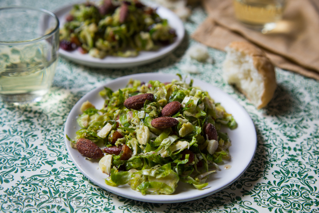 In this recipe for shredded Brussels Sprouts salad, the veggies are tossed with smoked almonds and cranberries and topped with an orange maple dressing | FakeFoodFree.com