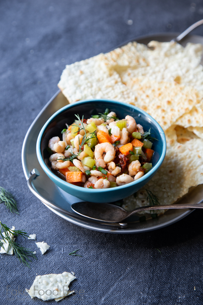 A recipe for tangy pickled shrimp with carrots, cucumber, and sundried tomatoes. Find it at FakeFoodFree.com.