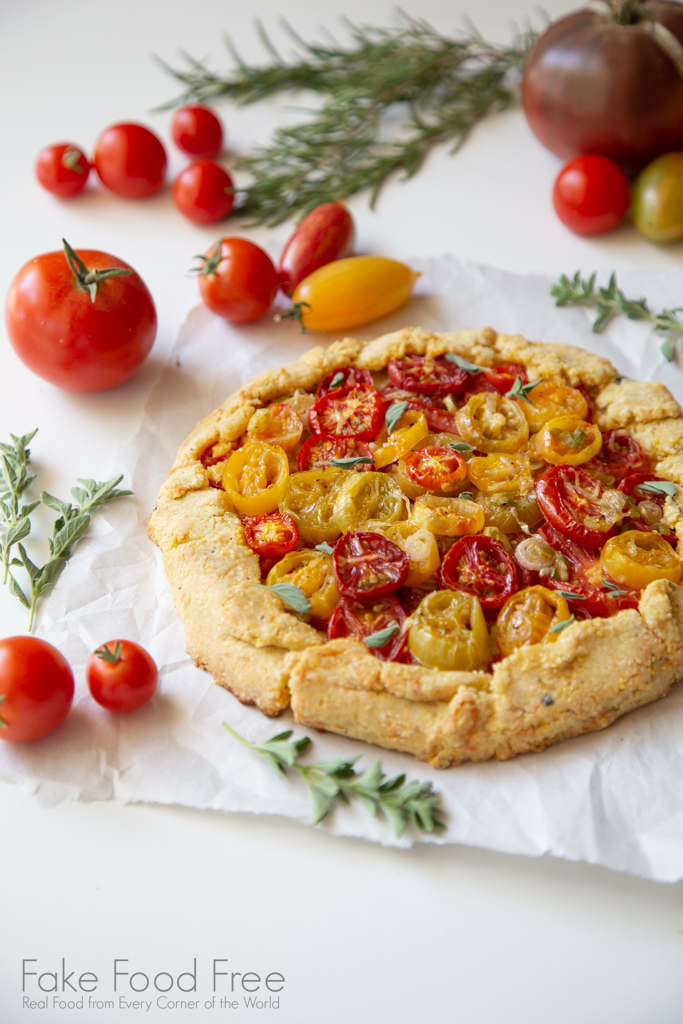 Heirloom Cherry Galette Recipe with green onions, herbs, and a cornmeal crust | Recipe at FakeFoodFree.com #summer #recipes #tomatoes