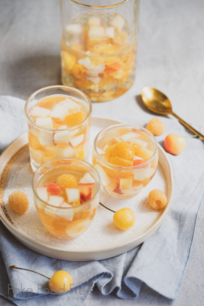 Golden Sangria Recipe made with white wine, golden raspberries, white peaches, and Rainier yellow cherries. | FakeFoodFree.com #wine #whitewine #cocktails #sangriarecipes #sangriaideas #yellowcherries #goldenraspberries