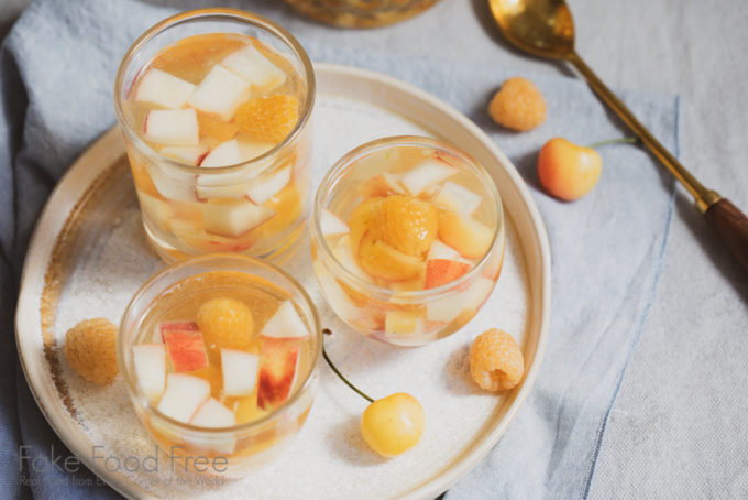 Golden Sangria recipe made with white wine and white and yellow fruits. | FakeFoodFree.com #wine #whitewine #cocktails #sangriarecipes #sangriaideas #yellowcherries #goldenraspberries