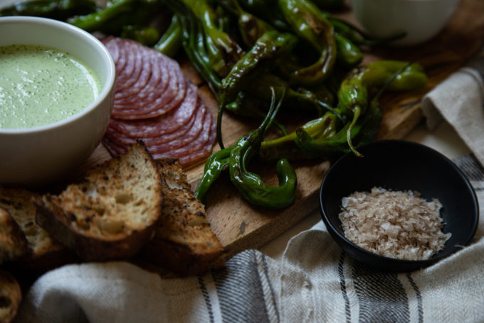 Shishito Pepper Board Party Idea served with Cilantro Crema and Tequila Honey | FakeFoodFree.com #appetizers #partyfood #partyideas #charcuterieboard #starters 